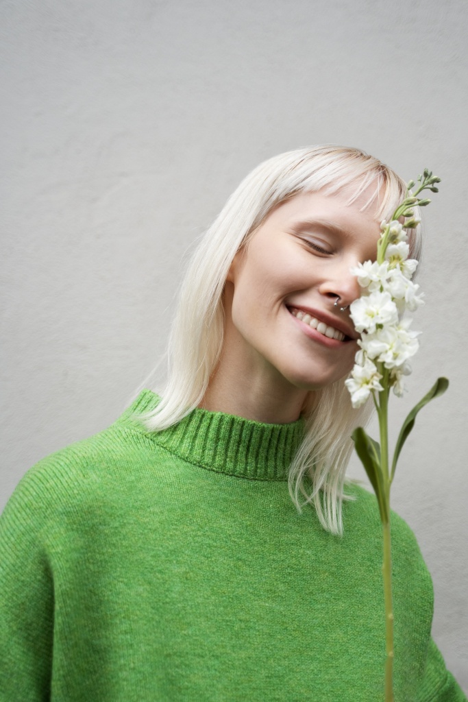 medium-shot-woman-posing-with-flower.jpg